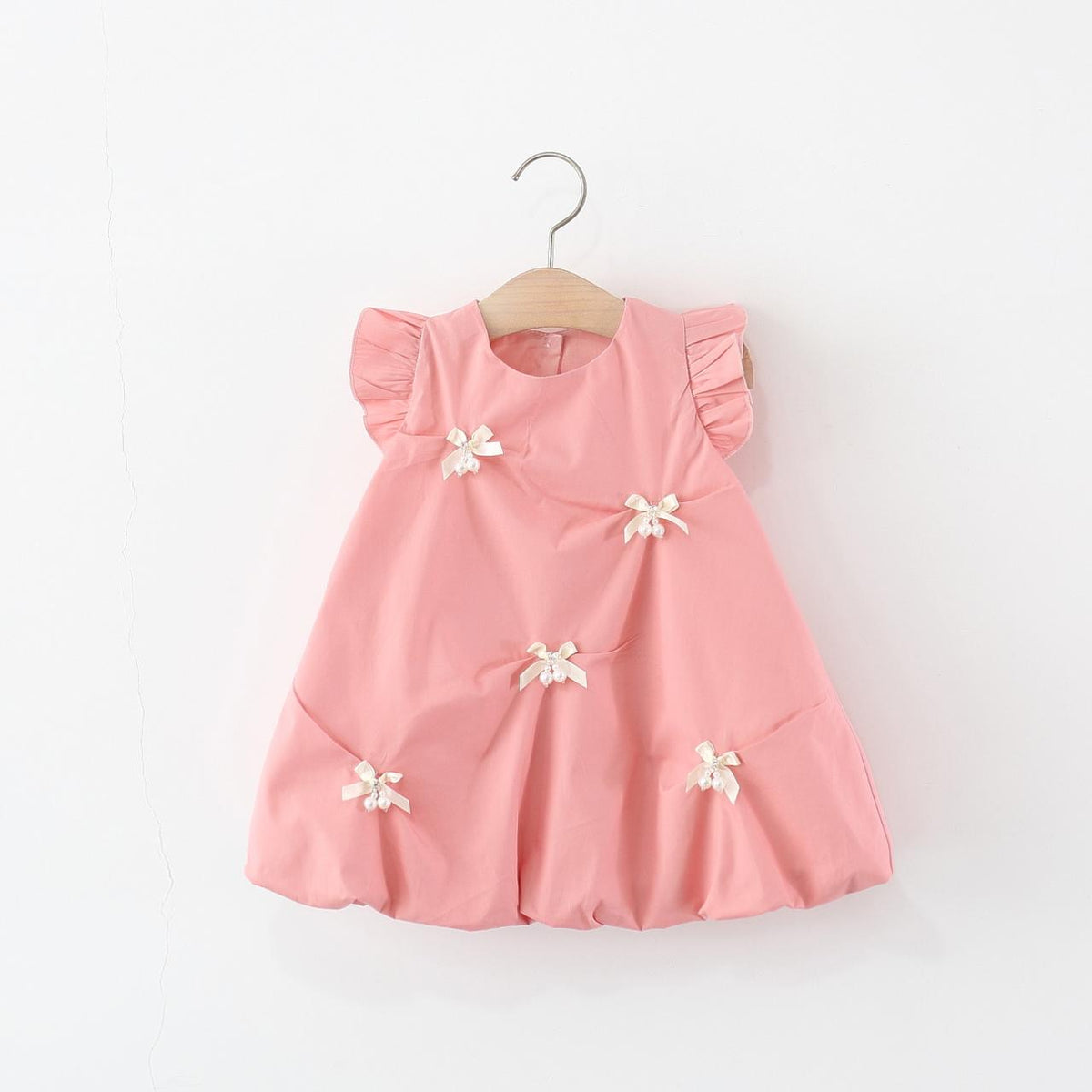 Vestido casual rosa estilo globo con detalles de moño y perlas