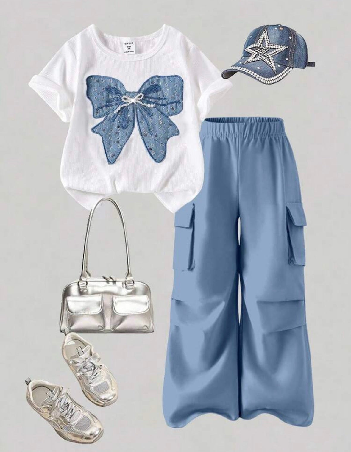Conjunto pantalón celeste con remera , detalle de moño con perlas y lentejuelas