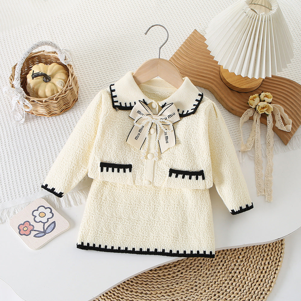 Conjunto pollera con abrigo suéter , detalles en negro y moño de perlas ( textura oveja)