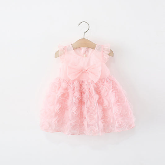 Vestido rosa con flores en 3D y detalle de moño grande (atrás lleva cierre)