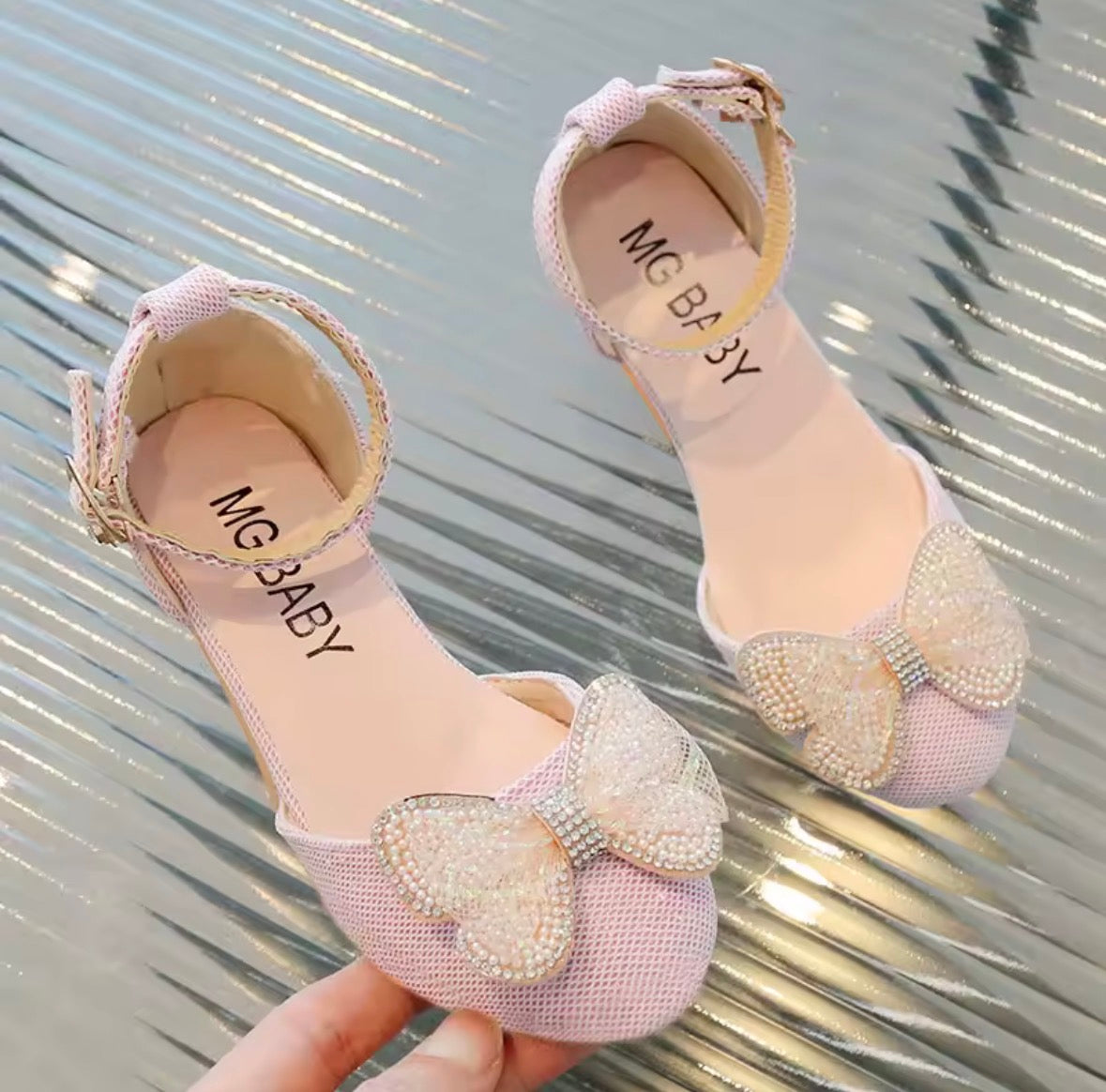Zapato rosa con pequeño taco y detalle de moño con perlas