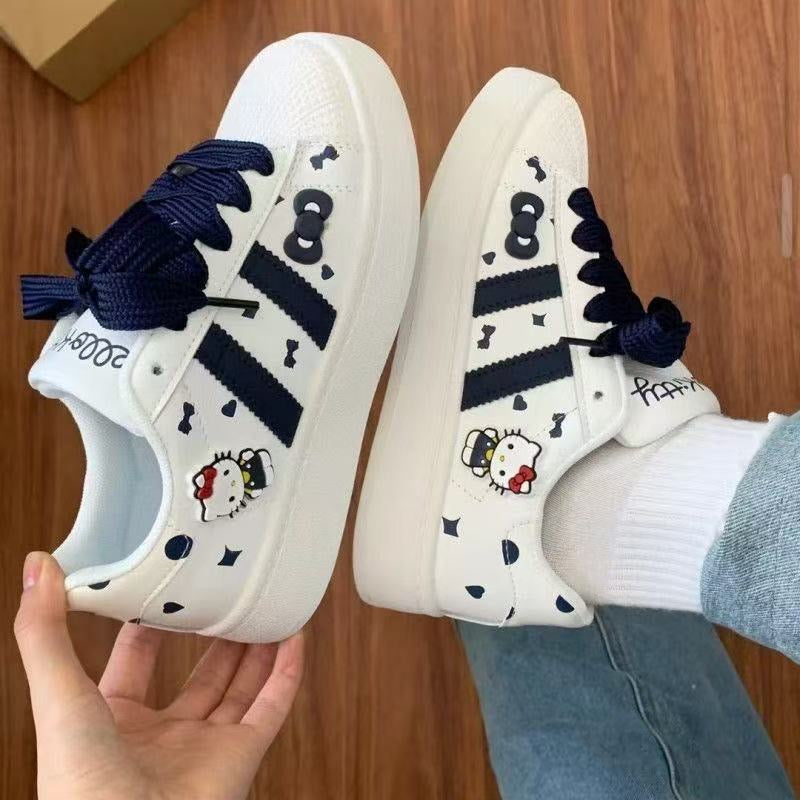 Tenis ( Champion ) blanco estilo tapita , con detalles en azul   de hello Kitty