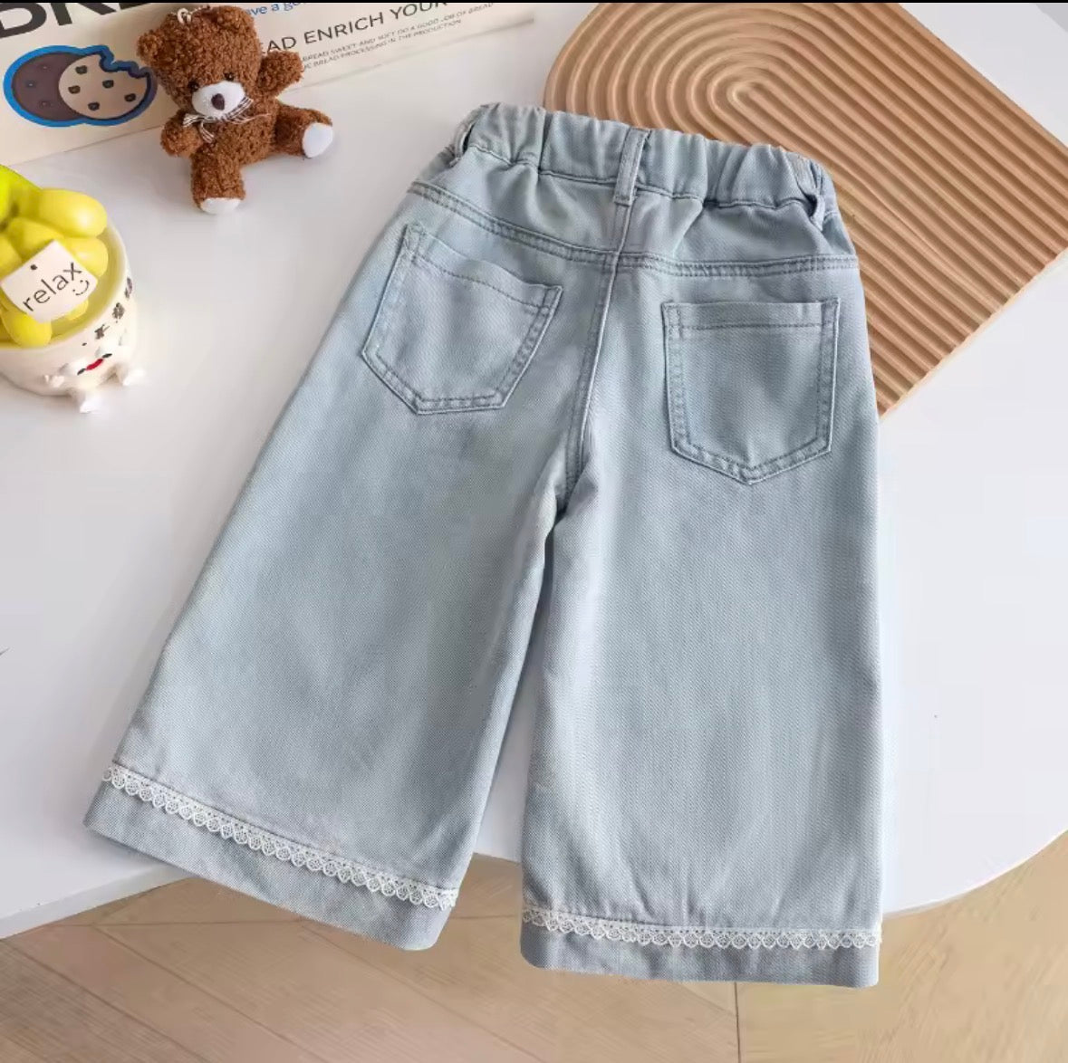 Pantalón de jeans detalle de moños y bolsillo atrás