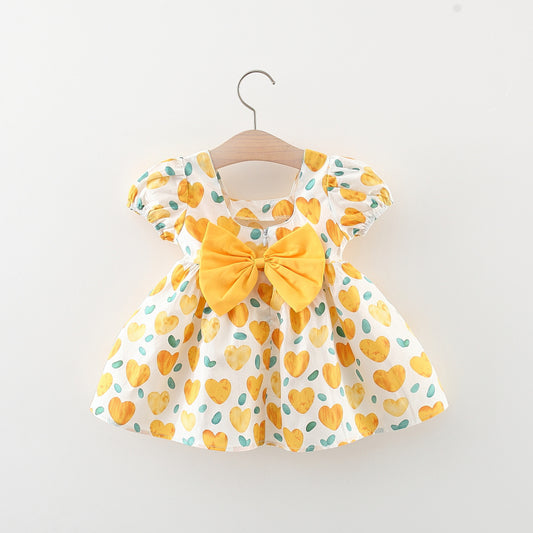 Vestido estampado amarillo con detalle de moño y corazones